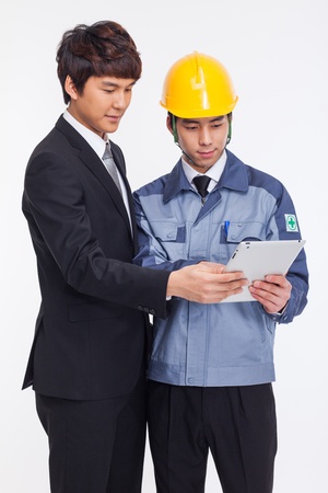 Asian business man and engineer have a pad PC isolated on whiteの写真素材