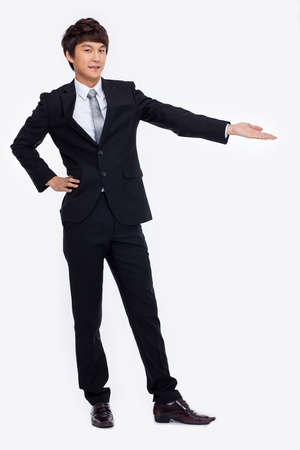 Young Asian business man showing something isolated on white background. の写真素材