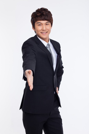 Young business man extending hand to shake isolated on white background. の写真素材