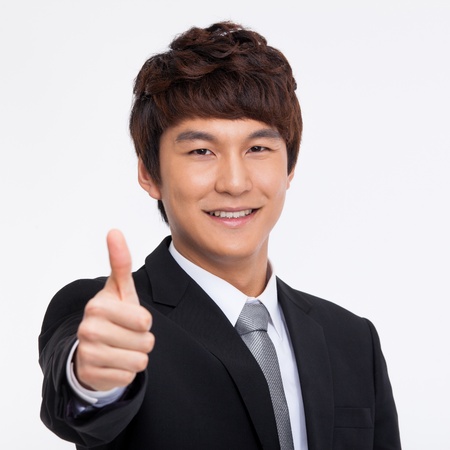 showing thumb Asian young business man close up shot  isolated on white background.の写真素材