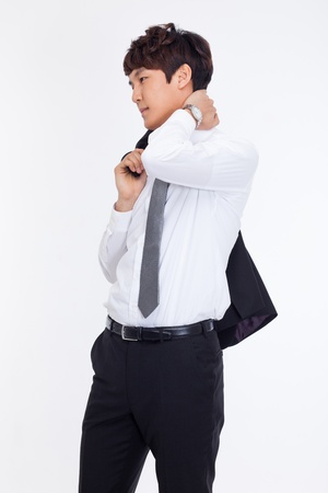 A tired Asian business man isolated on white background.の写真素材