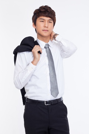 A tired Asian business man isolated on white background.の写真素材