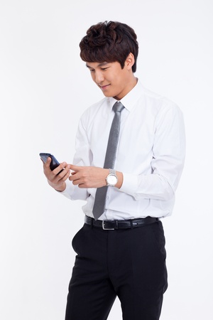 Asian business man with cellphone isolated on white background.の写真素材
