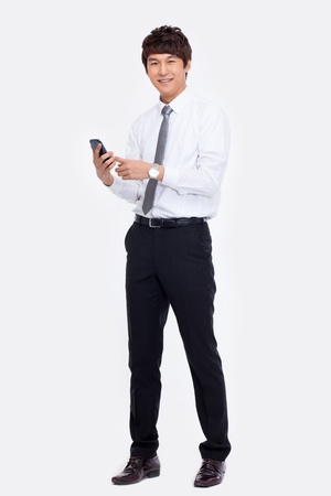 Asian business man with cellphone isolated on white background.の写真素材