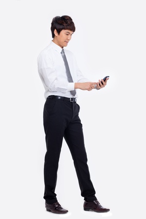Asian business man with cellphone isolated on white background.の写真素材
