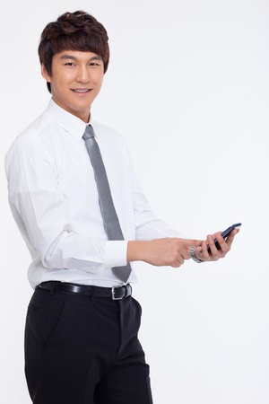Asian business man with cellphone isolated on white background.の写真素材