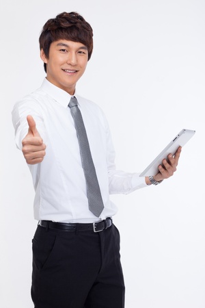 Young Asian business man using a pad PC isolated on white background. の写真素材