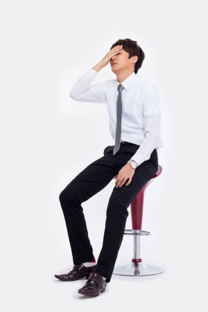 Young Asian man having a stress on isolated on white background. の写真素材