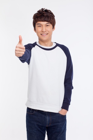 Young Asian man showing thumb isolated on white background. の写真素材