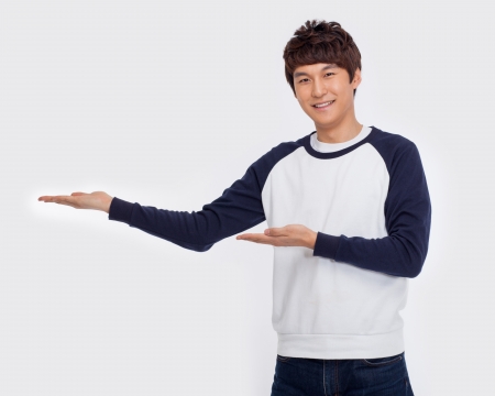 Asian man present something isolated on white background.の写真素材