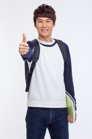 Young Asian student showing thumb isolated on white background. の写真素材