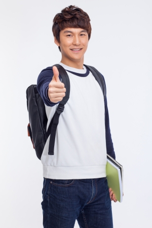 Young Asian student showing thumb isolated on white background. の写真素材