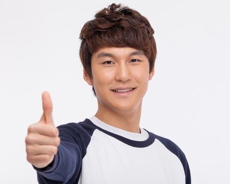 showing thumb Asian young business man close up shot  isolated on white background.の写真素材