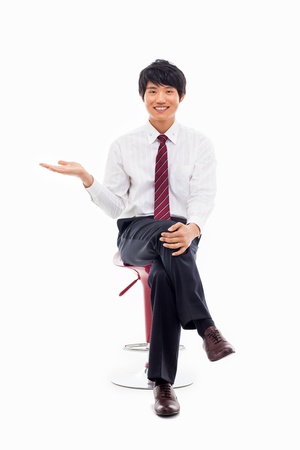 Young Asian business man showing something isolated on white background. の写真素材