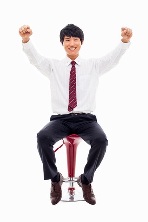 Sitting successful business man isolated on white background.の写真素材
