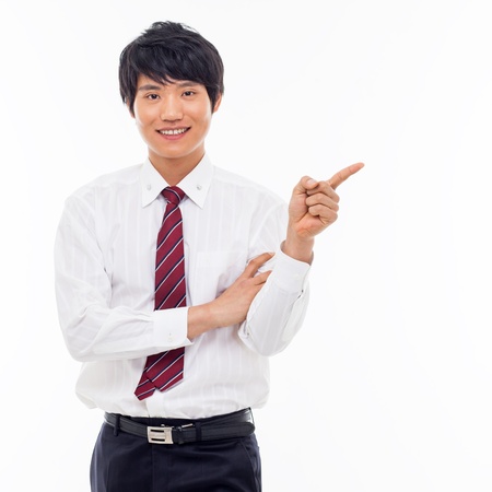 Young Asian business man showing something isolated on white background. の写真素材