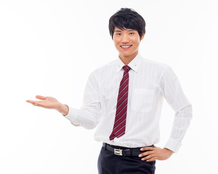 Young Asian business man showing something isolated on white background. の写真素材