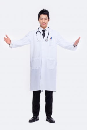 Young Asian doctor spread arms isolated on white background. の写真素材