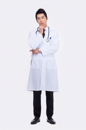 thinking Young Asian doctor isolated on white background. の写真素材