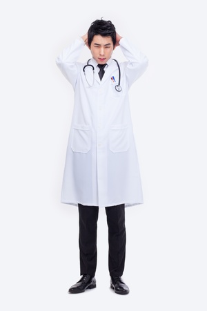 Young Asian doctor having a stress isolated on white background.の写真素材