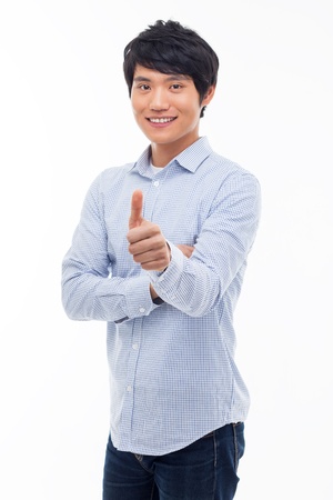 Young Asian man showing thumb isolated on white background. の写真素材