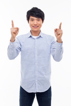Young asian man indicated upside isolated on white background. の写真素材