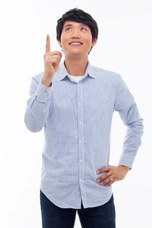 Young asian man indicated upside isolated on white background. の写真素材
