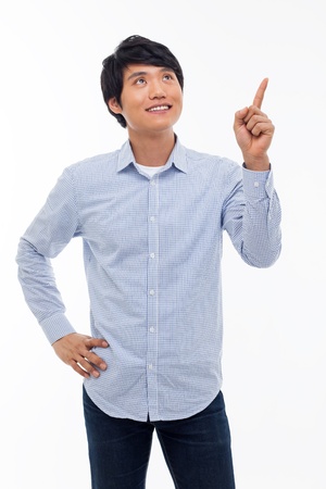 Young asian man indicated upside isolated on white background. の写真素材