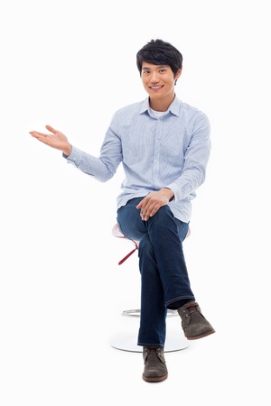 Asian man present something isolated on white background.の写真素材