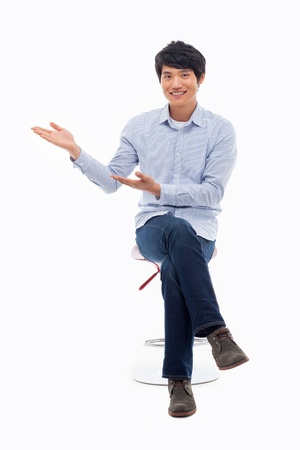 Asian man present something isolated on white background.の写真素材