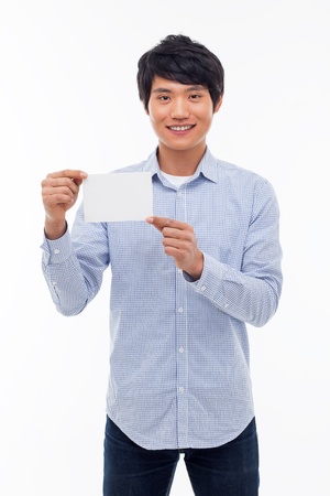 Young asian man showing empty card isolated on white background. の写真素材