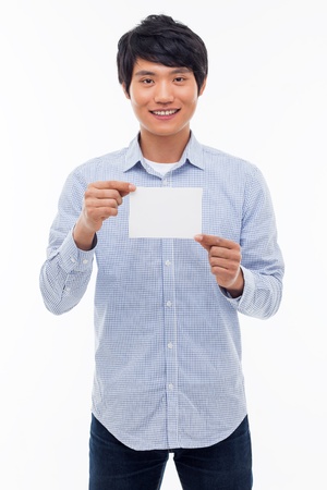Young asian man showing empty card isolated on white background. の写真素材