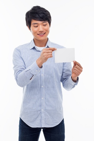 Young asian man showing empty card isolated on white background. の写真素材