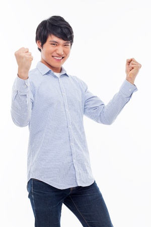 Young Asian man showing fist and happy sign isolated on white background. の写真素材