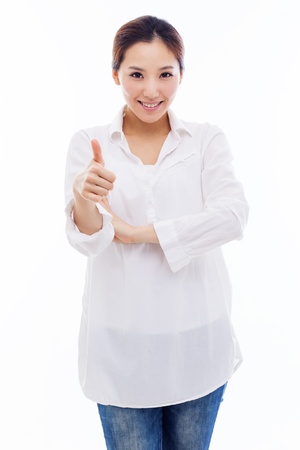 Young Asian woman showing thumb isolated on white background.の写真素材