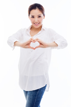 Beautiful Asian casual woman show heart shape isolated on white background. の写真素材