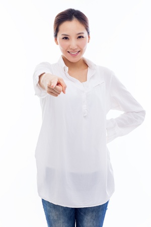 Young Asian woman pointing you isolated on white background.の写真素材