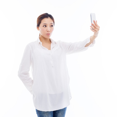 Young Asian woman using a smart phone isolated on white background. の写真素材