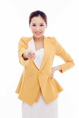 Young business woman pointing you isolated on white background.の写真素材