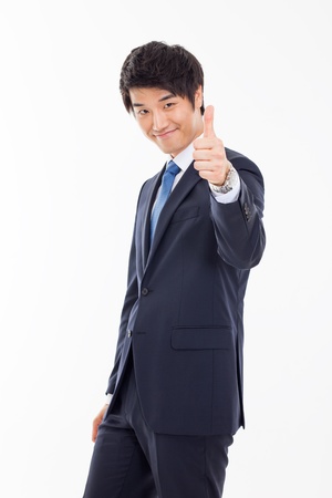 Showing thumb young Asian business man isolated on white background. の写真素材