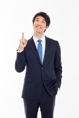 Young asian man indicated up side isolated on white background. の写真素材