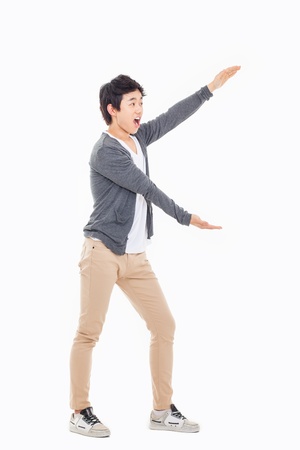 Asian man present something isolated on white background.の写真素材