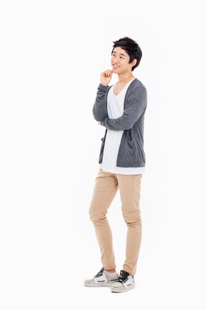 Thinking young Asian man isolated on white background. の写真素材