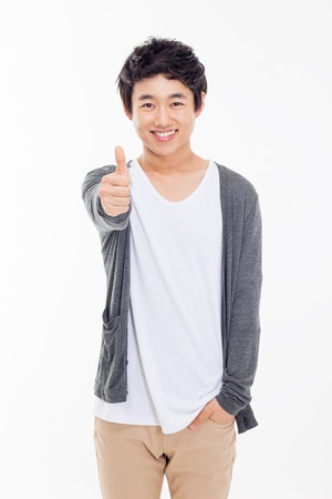 Young Asian man showing thumb isolated on white background. の写真素材