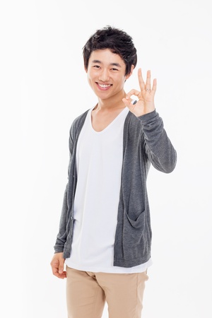 Young asian man showing okay sign isolated on white background. の写真素材