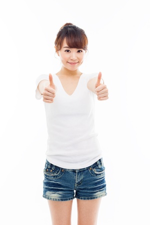 Young Asian woman showing thumb isolated on white background の写真素材