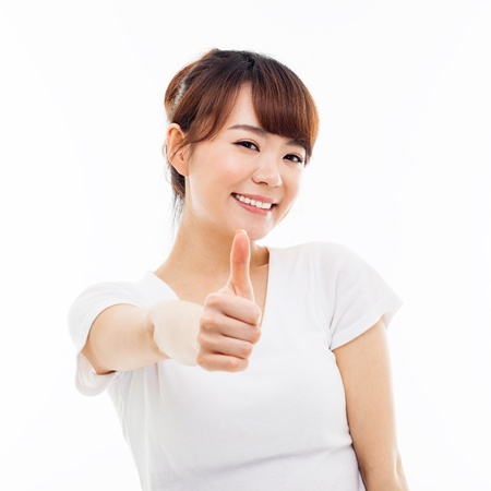 Young Asian woman showing thumb isolated on white background の写真素材