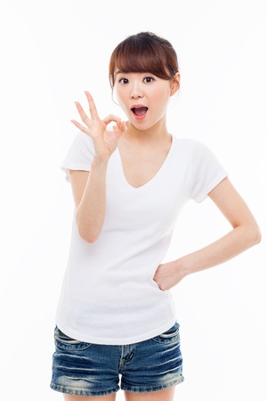 Cute woman with okay hand gesture isolated on white background. の写真素材