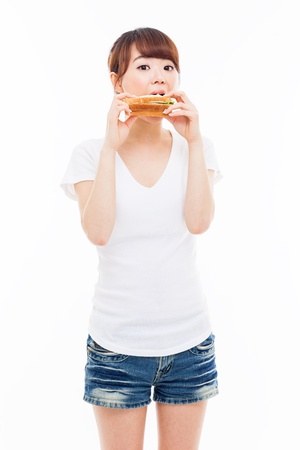 Young Asian woman eat sandwhich ioslated on white.の写真素材