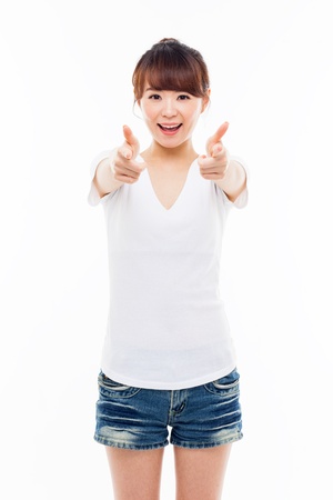 Young Asian woman pointing you isolated on white background.の写真素材